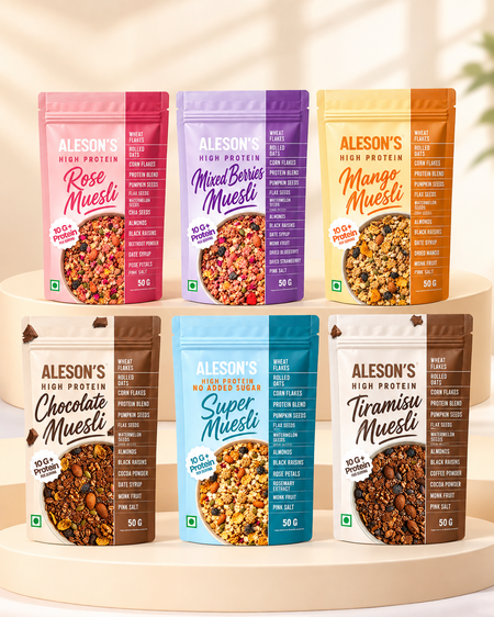 Six stand-up pouches of Aleson's High Protein Muesli. The flavors shown are Rose Muesli (pink), Mixed Berry Muesli (purple), Mango Muesli (yellow-orange), Chocolate Muesli (brown), Super Muesli (light blue), and Tiramisu Muesli (dark brown). FSSAI certified license number - 11524998001052